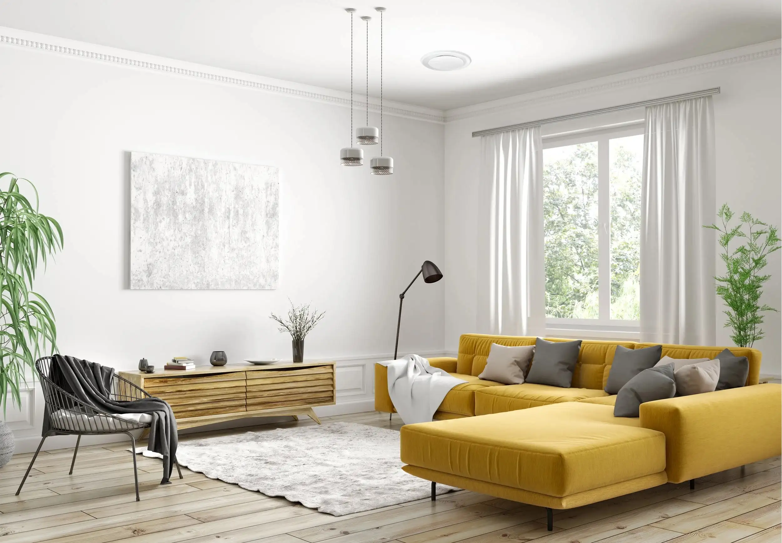 A white living room with a round air conditioning outlet set into the ceiling, a mustard yellow corner lounge below it under a curtained window, a timber sideboard against the wall and pale floorboards